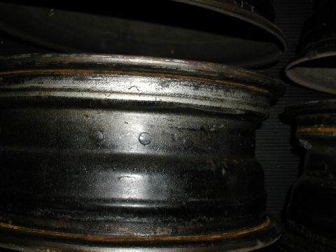 1967 Ford Ranchero - Several old steel car wheels are shown in this close-up image.