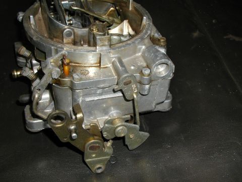 1967 Ford Ranchero - A detailed view of a carburetor, highlighting its mechanical components and metal construction.