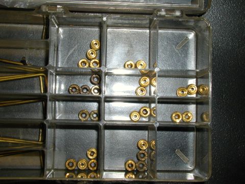 1967 Ford Ranchero - Small brass fittings organized in a clear plastic case with multiple compartments.