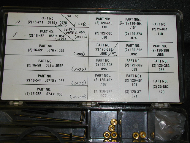 Carburetor jet assortment case with part-number chart label and brass jets in trays