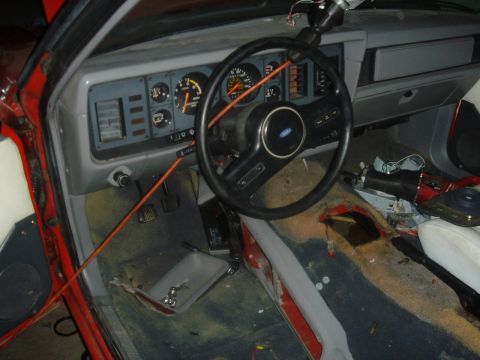 1986 Ford Mustang - The interior of a 1986 Ford Mustang shows the dashboard, steering wheel, and center console area.