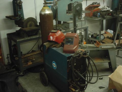 1978 Ford Bronco - Workshop scene with welding equipment, gas cylinder, and tools visible.