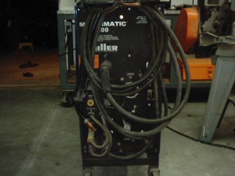 1978 Ford Bronco - A Miller Matic 200 welding machine is shown with its various cables and connectors.
