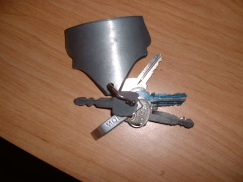 1978 Ford Mustang II - A keychain with multiple car keys and a metal fob sits on a wooden surface.