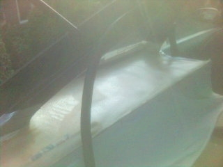 1994 Ford Probe - A car hood with the Supermotors logo is visible in this photograph.