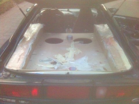 1994 Ford Probe - Custom speaker enclosures are under construction in the rear of a car.