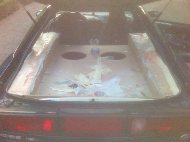 Car interior showing custom speaker enclosures being built in the rear cargo area