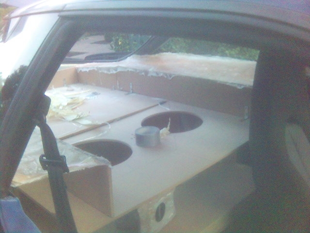 Custom speaker box with two circular cutouts in a car interior