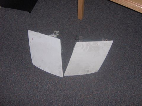 1994 Ford Probe - Two white car headlights are shown on a carpeted surface, with a watermark indicating they are from Supermotors.net.