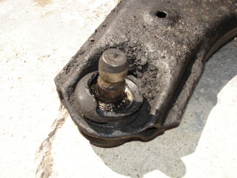 1989 Mazda MX-6 - This close-up shows a heavily greased and worn ball joint, a critical suspension component.