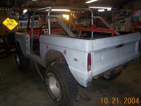 1974 Ford Bronco - Rear view of a 1974 Ford Bronco undergoing modifications in a workshop.