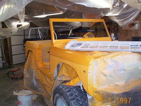 1974 Ford Bronco - 1974 Ford Bronco body undergoing paint preparation in a garage.