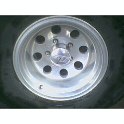 1981 Ford Bronco - Close-up of an aftermarket aluminum wheel with a 'SUPER' center cap.