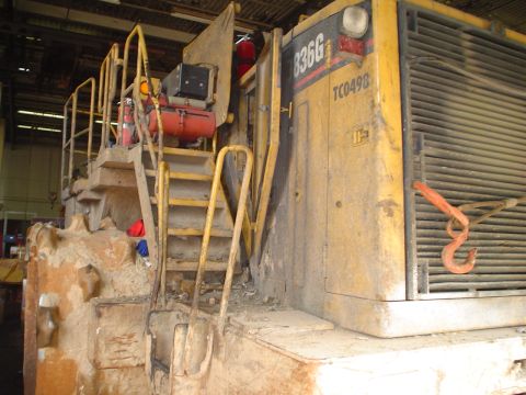 1966 International School Bus - A close-up view of a large yellow piece of heavy machinery, possibly a bulldozer or scraper, with visible model numbers.