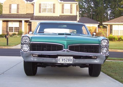 1967 Pontiac Lemans - Front view of a 1967 Pontiac Lemans parked in a driveway, showing its grille and headlights.