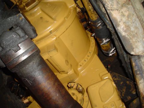 1966 International School Bus - Close-up view of engine components, including a drive shaft and hoses, with visible text from a website.
