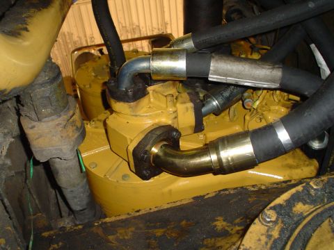1966 International School Bus - Close-up view of yellow engine components and hoses, with visible text indicating 'Filter'.