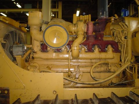 1966 International School Bus - Close-up view of a large yellow engine with a prominent air filter and fan.