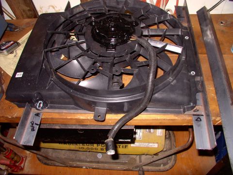 1990 Lincoln Town Car - The Taurus fan sits on the steel to check for fit and to allow me to drill locating holes for the 4 stock Taurus shroud mounting holes.