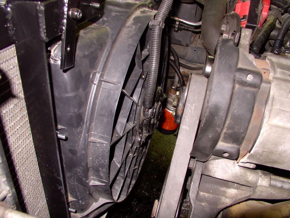 Plenty more room than the stock clutch fan's shroud gives you, in every way. I drilled and tapped the little welded (and nutted) tab in the top left of the picture to hold the stock Lincoln rad overflow tank in place.