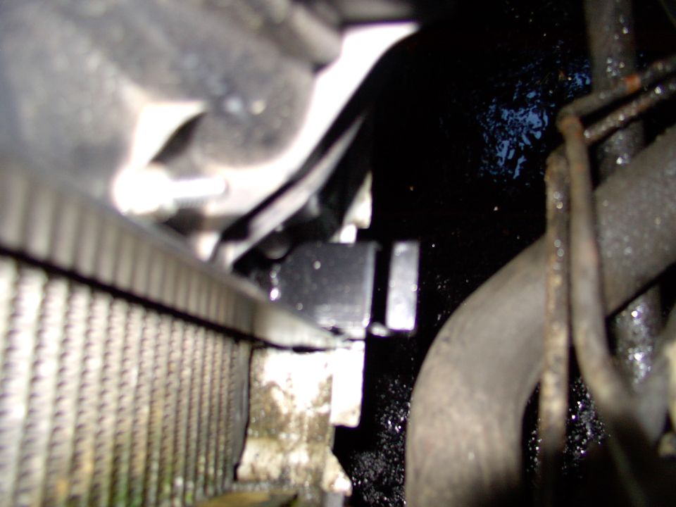 This pic is way out of focus, but maybe you can see the notched angle steel, ready to accept and locate the stock Lincoln overflow tank's lower tab.