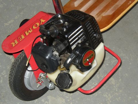 1987 Volkswagen Golf - Close-up of a Yomer motorized skateboard engine and deck.