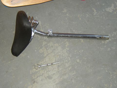1987 Volkswagen Golf - A vintage-style bicycle seat with chrome springs and post is shown, along with a retaining pin.