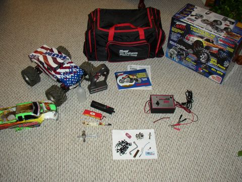 1987 Volkswagen Golf - Collection of remote control car parts including bodies, charger, remote, batteries, and tools.