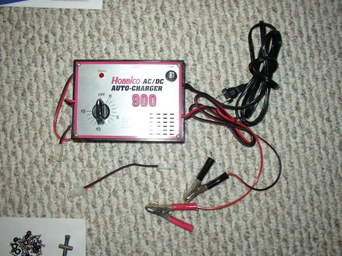 1987 Volkswagen Golf - A Hobbico AC/DC Auto-Charger 900 is shown with its accessories on a carpeted surface.
