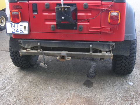 2001 Jeep Wrangler - Rear view of a red 2001 Jeep TJ showing the bumper, spare tire mount, and license plate.