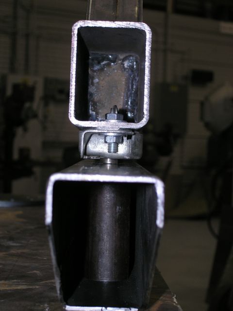 2001 Jeep Wrangler - Metal bracket assembly with visible bolt and nut connection.