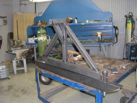 2001 Jeep Wrangler - A custom metal bumper assembly is seen on a blue cart in a workshop environment.
