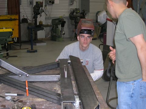 2001 Jeep Wrangler - Metal fabrication project underway in a workshop with two individuals present.