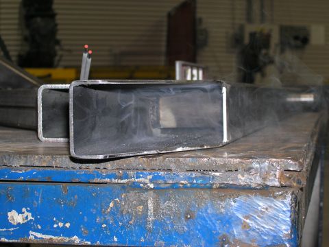 2001 Jeep Wrangler - Two metal tubes are shown on a workbench, with one tube's open end facing the camera.