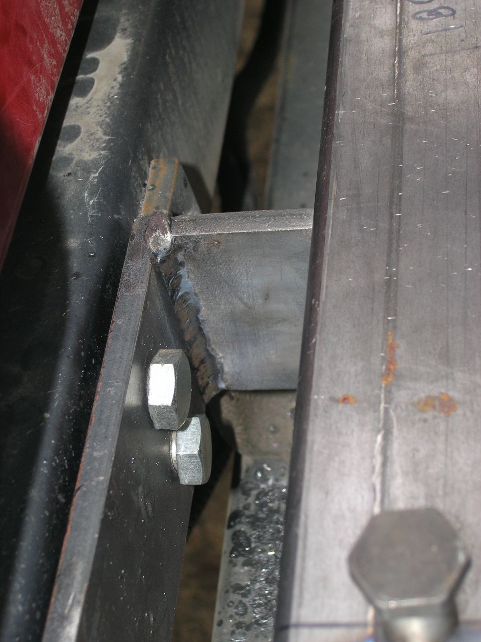 Welded metal bracket attached with two hex bolts