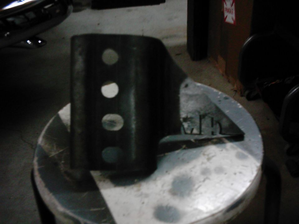 Metal bracket with three circular holes and a triangular base