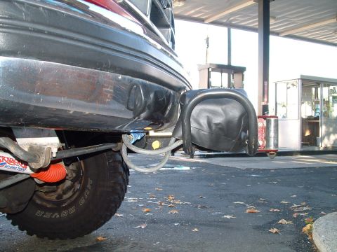 1994 Ford Bronco - A close-up view of a vehicle's rear bumper and tire, showing a winch and a 'Mud Rover' tire.
