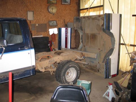 1989 Ford F-150 - The chassis and bed of a Ford truck are visible, with the cab on the left side of the frame. The truck appears to be undergoing repairs or…