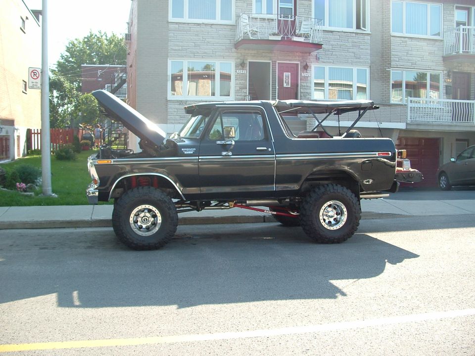 Black lifted 1979 Ford Bronco side view, hood open