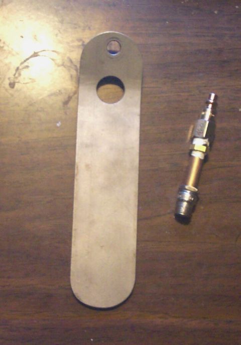 1979 Ford F-150 - A metal plate and a tire valve stem are shown on a wooden surface. The website SUPERMOTORS.NET is visible at the bottom.