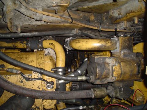 1966 International School Bus - A view of the engine compartment showing yellow hoses and mechanical components.