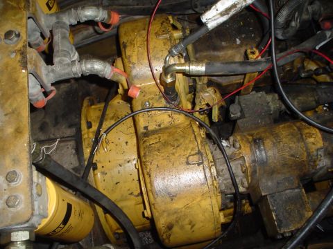 1966 International School Bus - Close-up of engine parts, hydraulic lines, and a CAT oil filter.