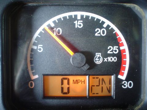 1966 International School Bus - Close-up of a vehicle's dashboard gauges, displaying speed and gear selection.
