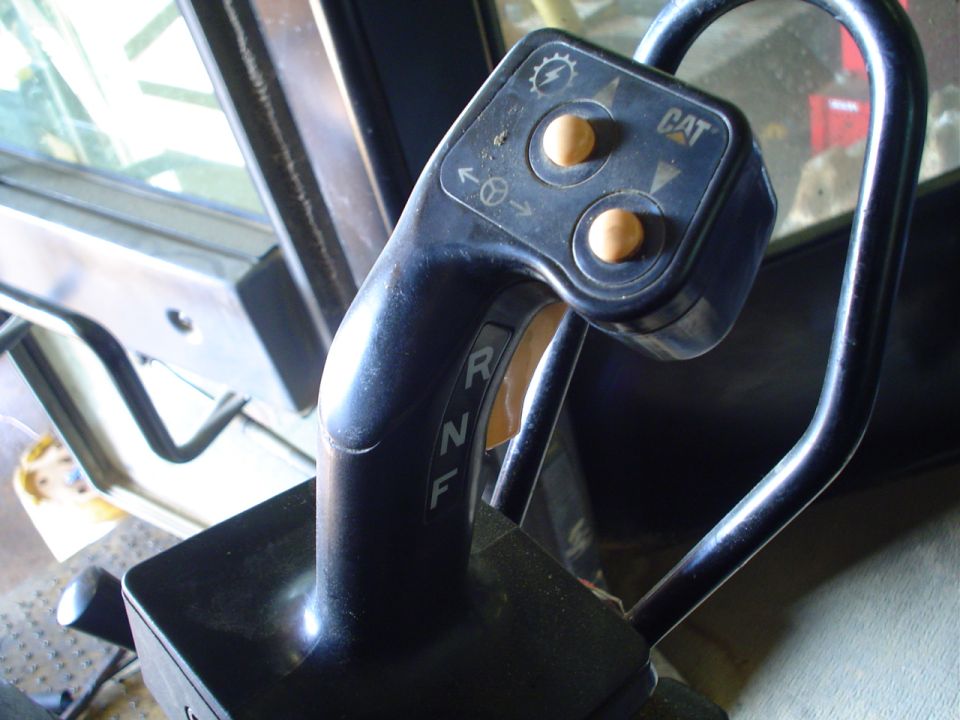 Close-up of CAT equipment interior with gear shifter and control buttons