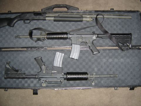 1988 Ford Bronco - A shotgun and two rifles are arranged in a black case, ready for transport.