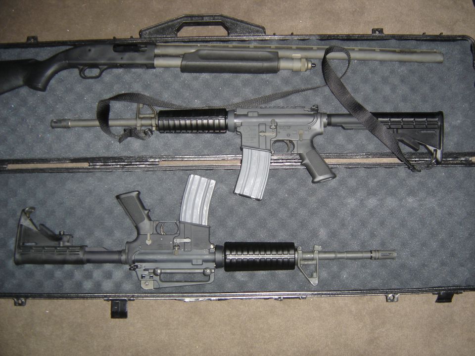 Three firearms, including a shotgun and two rifles, lie in a black case with foam cutouts