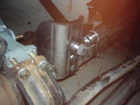 1978 Ford Bronco - This image shows a close-up of vehicle suspension parts, including a bracket and control arm, with a SuperMotors watermark.