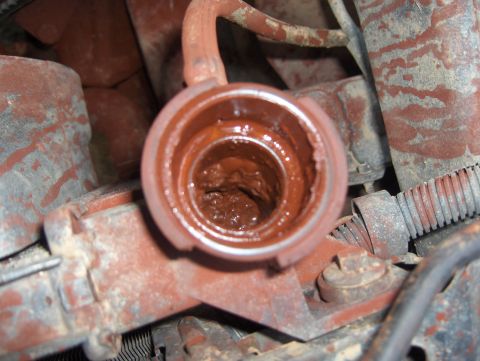 1985 Ford Bronco II - The radiator cap opening shows significant rust and buildup within the engine compartment.