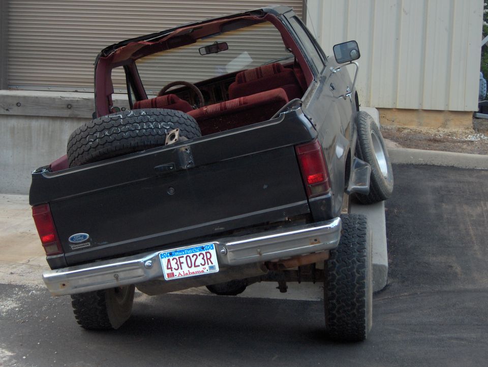 Black 1985 Ford Bronco II with a spare tire in the bed, viewed from the rear