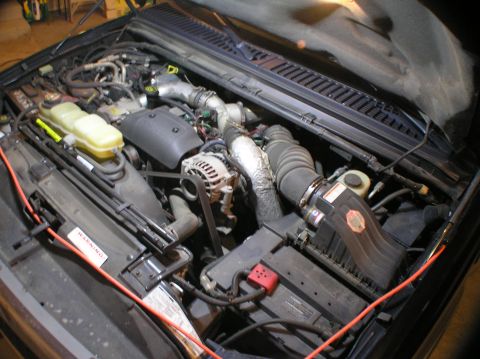 2000 Ford Excursion - Overview of engine compartment before the alternator install (the orange cord is an extension cord ran to the lights I have hanging under t…